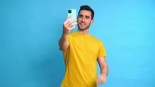 Expressive Young Adult Takes Playful Mobile Phone Selfies