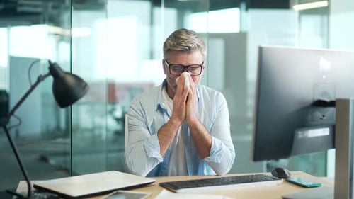 Ill Man Blows Nose at Office Desk