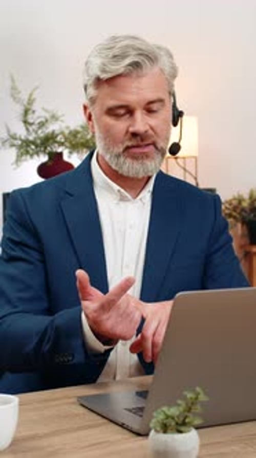 Middleaged Businessman in Headset Runs Call Center Support Listening Client Smiling Delivering Help