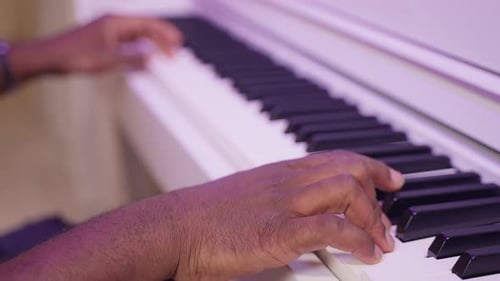 Hands of Professional African American Musician Playing on Piano Closeup View