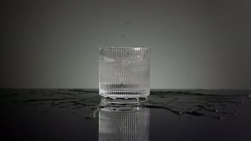 Ice Cubes Splashing into Glass of Water
