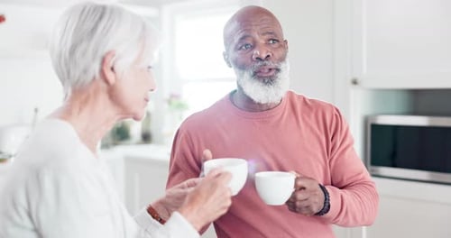 Senior Couple Drinking Tea Together in Bright Kitchen