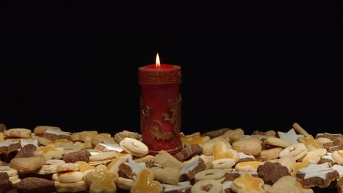 Festive Sugar Cookies with Lit Christmas Candle