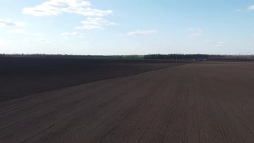 Tractor with yellow seeder working on the field in Ukraine OA Lexa