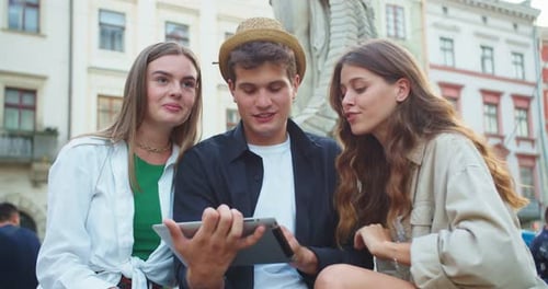 Portrait of Joyful Caucasian Friends in City Using Gadget Handsome Guy Typing and Searching Internet