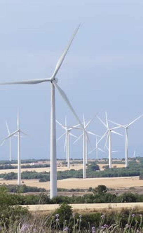 Wind Turbines Spinning in Rural Field, Clean Energy