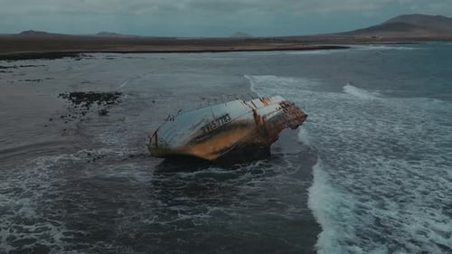 Aerial 4k drone footage of shipwreck on the Ocean's shore