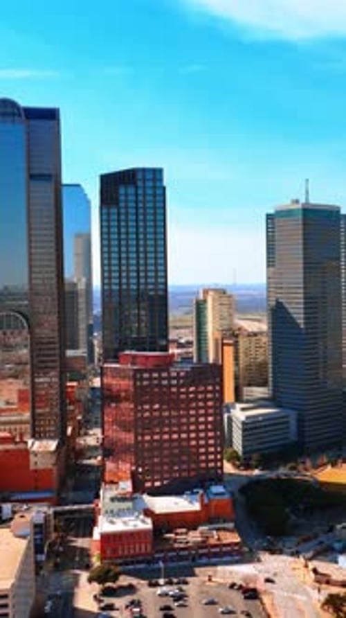 Sunny scenery of Dallas, Texas, USA. Drone rising along the majestic skyscrapers in the city
