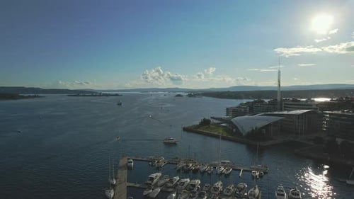 Boats are docked in the peaceful waters of Aker Brygge in Oslo Norway