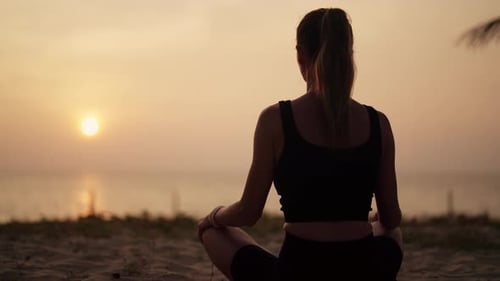 Woman Practices Yoga on Ocean at Sunset Silhouette Sporty Yoga Girl Doing Yoga Pose Asana Exercise
