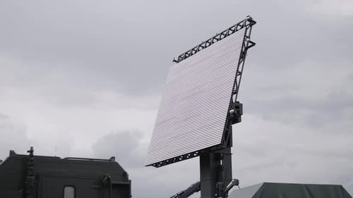 Advanced Radar System Demonstration at Military Base in Urban Setting Under Cloudy Skies Showcasing
