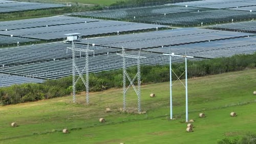 Aerial View of Big Sustainable Electric Power Plant with Many Rows of Solar Photovoltaic Panels for