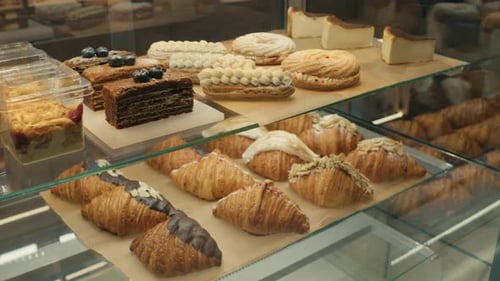 Sweet Baked Goods for Sale on Display Shelves in Bakery