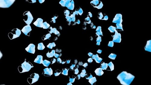 Multiple blue surgical masks floating in air against black background