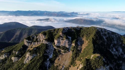 Aerial View of Mountainous Landscape with Forests Valley Full of Fog