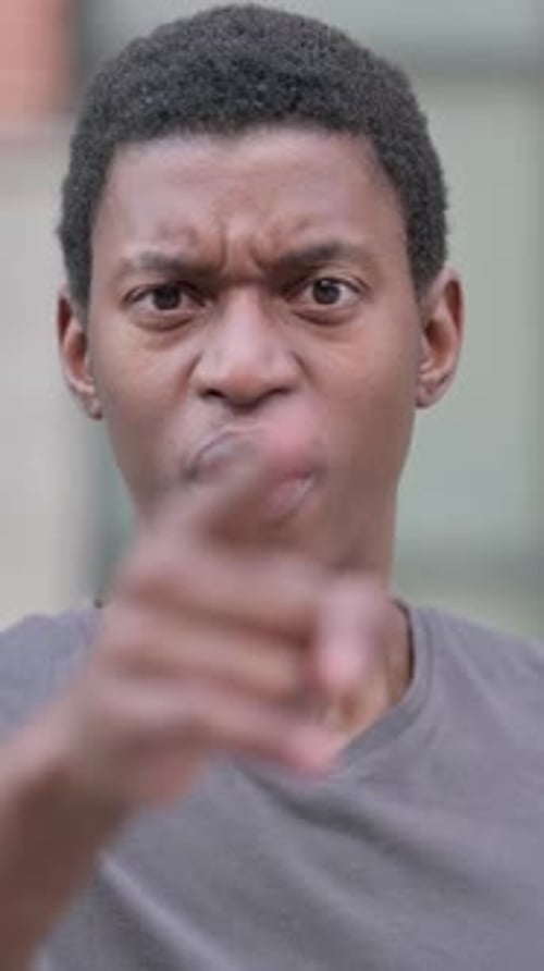 Angry Young Man Pointing and Arguing Aggressively
