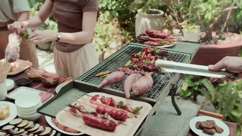 Friends Barbecue Delicious Food on Grill Outdoors