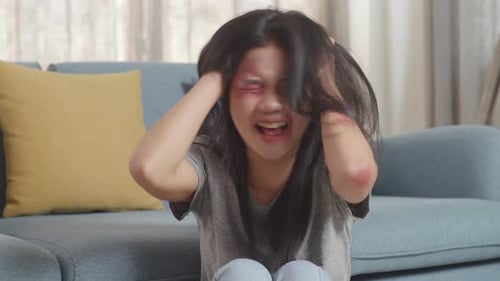 Upset Woman Cries with Visible Marks and Bruises