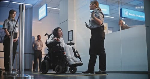 Security Checkpoint in Airport Terminal Female Security Officer Inspects Woman in Wheelchair