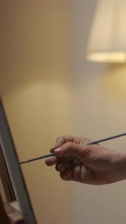 Woman Painting Indoors with a Brush on Canvas