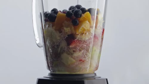 Electric Blender Blending Tasty Organic Fruits Berries with Fresh Water for Natural