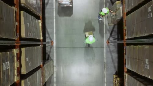 Warehouse Workers Working in Logistic Centre