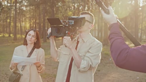 Camera Crew Films in the Forest at Daytime