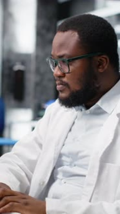 Researcher uses Microscope and Types on Computer