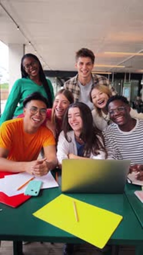 Vertical Portrait Group of Young Teenage Students Waving Hands at Library Using a Laptop Looking at