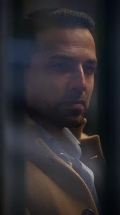 An Introspective Man Immersed in a Dynamic Urban Environment Captured Through Artistry