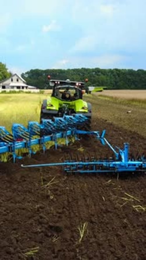 Tractor Working In The Agricultural Field. Agricultural equipment ready for ploughing the fields