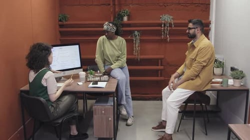 Female Manager Discussing Project Workflow with Diverse Team