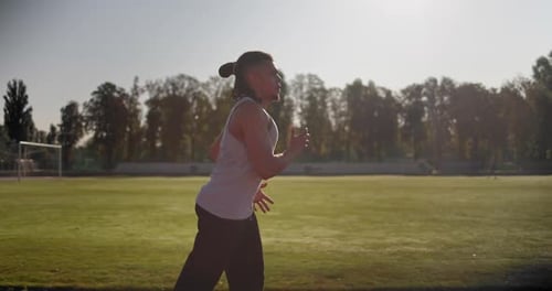Young African American Runner Athlete Jogging at the Stadium
