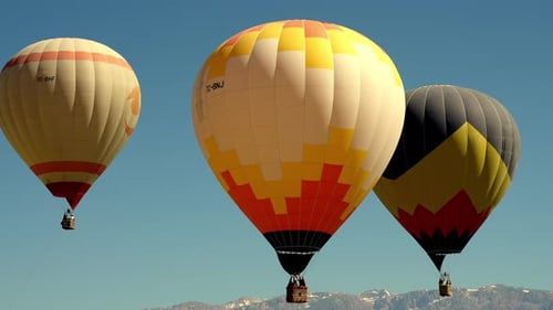 4K Aerial view of Goreme. Colorful hot air balloons fly over the valleys.