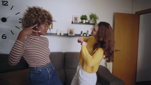 Lesbian Excited Girls Couple Dancing Fun in Living Room at Home Young Attractive Women Enjoying