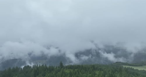 Mystical Mountains with Clouds Over Forest