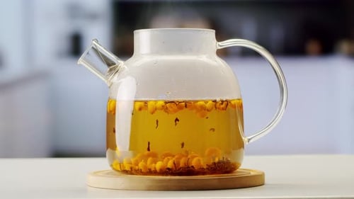 Argousier, baies saines pour le thé, boisson, baies mûres surgelées dans un bocal en verre et branches avec