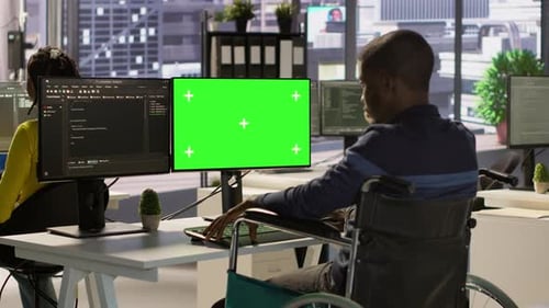 Person with Disability in Wheelchair Checking Code on Mockup PC