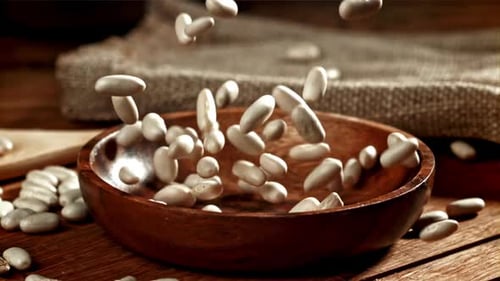 Lima Beans Poured Into Wooden Bowl on Table
