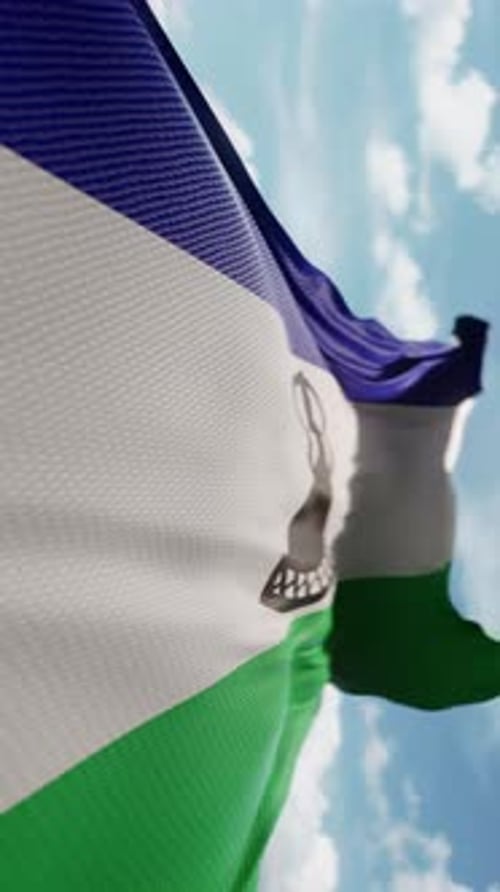 Lesotho Flag Waving Realistically In Blue Sky