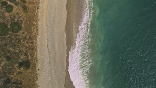 Fixed aerial view of an empty beach