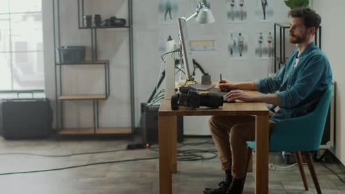 Professional Photographer Sitting at His Desk Uses Desktop Computer in a Photo Studio Retouches. Af