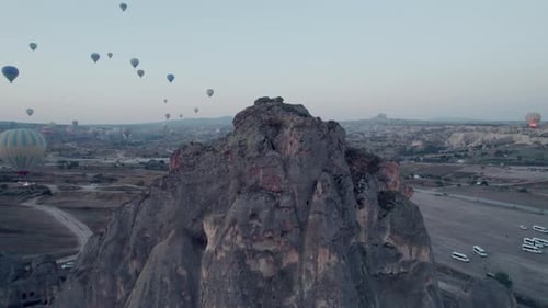 Aerial view of Cappadocia rock formation with hot air balloons in the sky