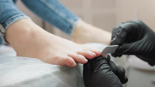 Filing Toenails for Pedicure Treatment at Salon