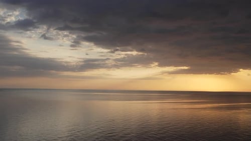 Beautiful Ocean View at Sunrise with Cloudy Sky