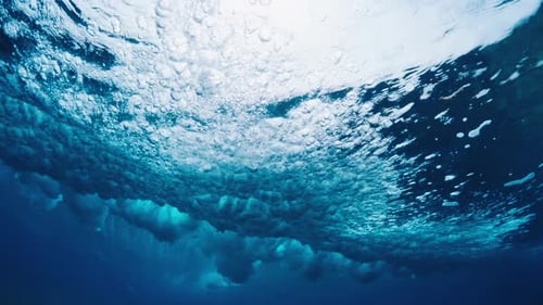 Ocean wave breaks at Sultans surf spot in Maldives. Tropical crystal clear wave breaks