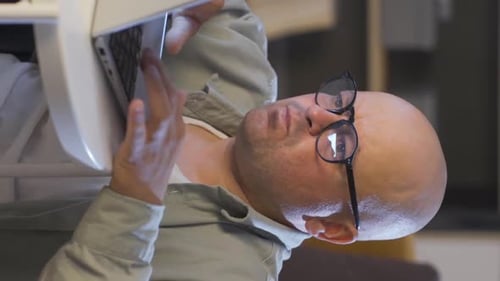 Man Typing on Laptop Indoors Close Up