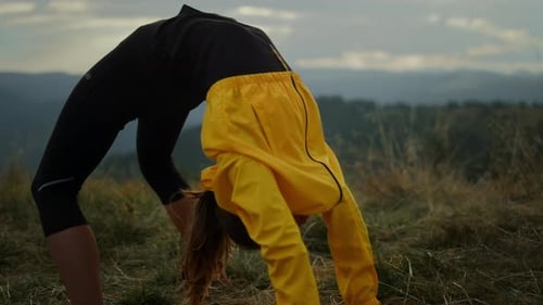 Flexible Woman In Sportswear Performing Bridge Yoga Pose In Mountain Landscape. Athletic Girl Str...
