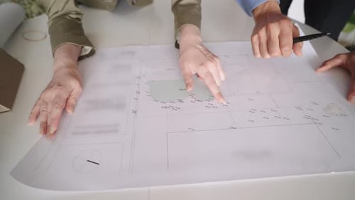 Architects and Engineers Discussing a Building Blueprint