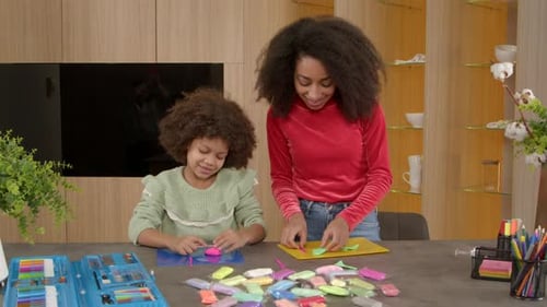 Child and Young Adult Making Clay Art at Home